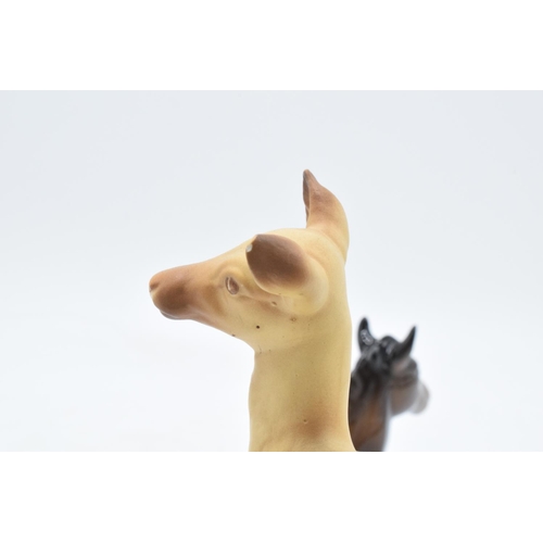 166 - Beswick items to include a brown lying down foal 915, a brown Shetland and a matte doe (3). In good ... 