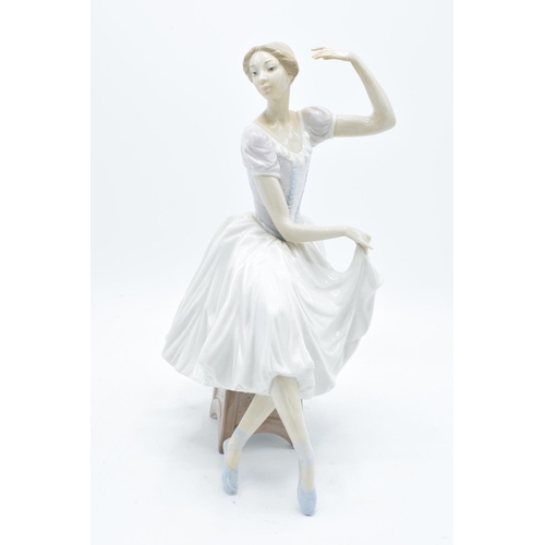 189 - A large Lladro figurine of a ballerina perched on a stool. A-21E. 29cm tall. In good condition with ... 