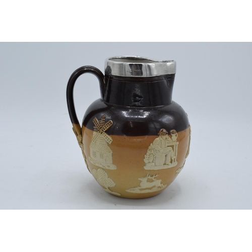 190 - Royal Doulton stoneware jug decorated with harvest scenes and a hallmarked silver rim. In good condi... 