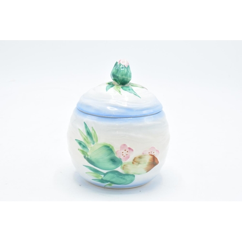 191 - Clarice Cliff (Newport Pottery) preserve pot in the Apple Blossom design with a bud finial. In good ... 