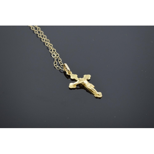 201 - A 9ct gold (stamped 375 Italy) crucifix pendant on a gold chain. 0.8 grams. 46cm in length with the ... 