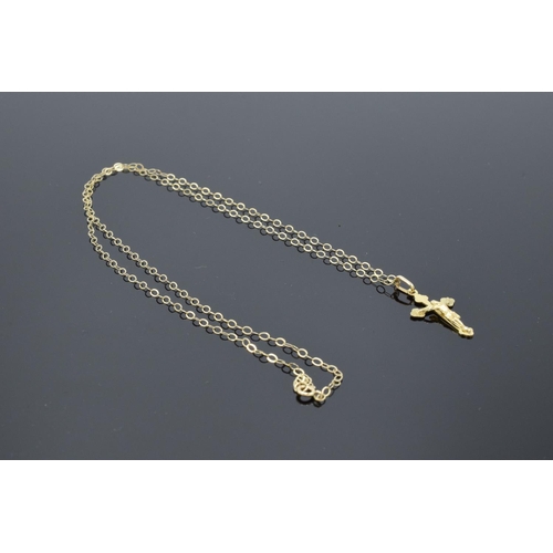 201 - A 9ct gold (stamped 375 Italy) crucifix pendant on a gold chain. 0.8 grams. 46cm in length with the ... 