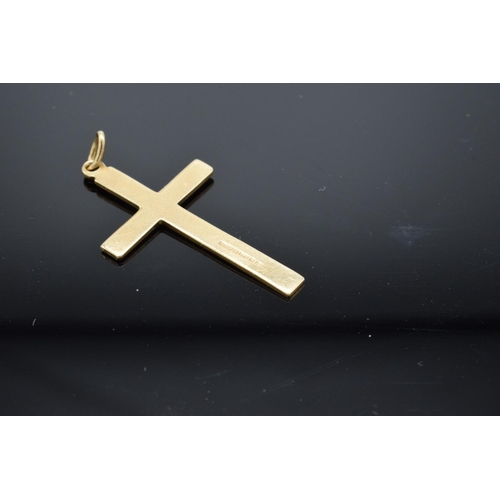 202 - A hallmarked 9ct gold crucifix pendant, 3cm in length. 1.2 grams.