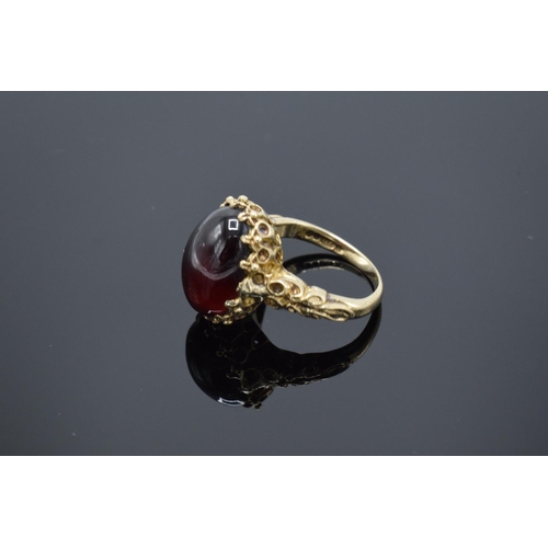 210 - A hallmarked 9ct gold ornate ladies ring set with a polished cabochon stone, gross weight 5.5 grams.... 