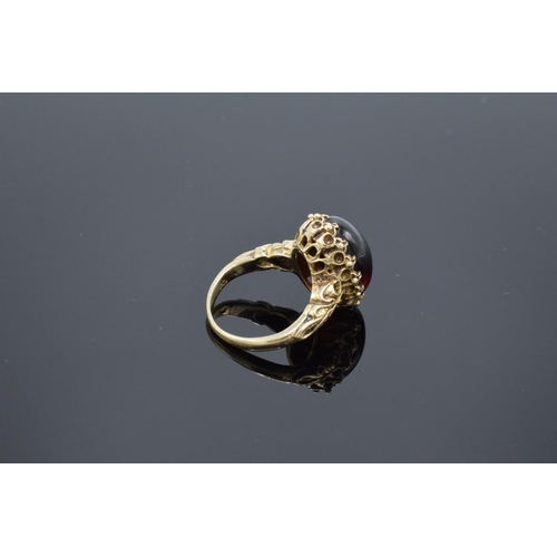 210 - A hallmarked 9ct gold ornate ladies ring set with a polished cabochon stone, gross weight 5.5 grams.... 