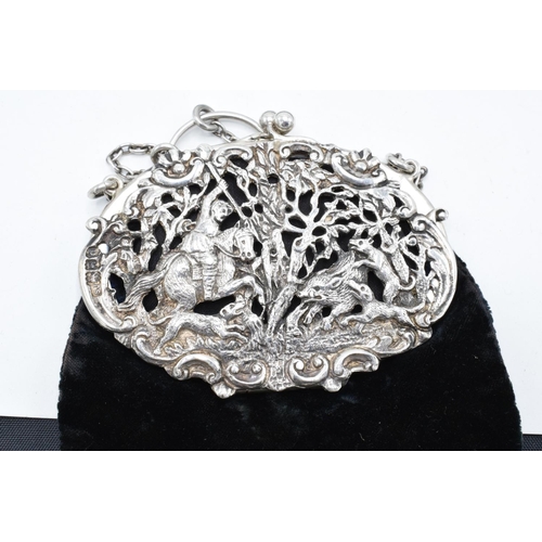 212 - An ornate silver ladies velvet purse with a ball clasp depicting a hunting scene. Hallmarked for Lon... 