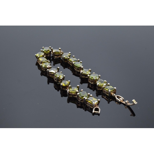 219 - A silver ladies bracelet set with semi-precious green stones, 20cm in length. 23.2 grams gross weigh... 