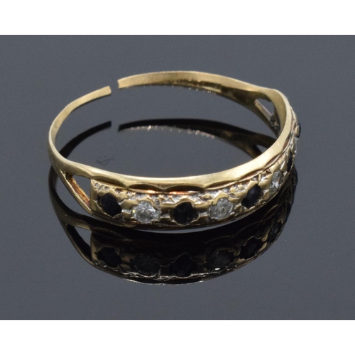 222 - A 9ct gold ladies ring set with diamond and sapphires (possibly synthetic). The band has been cut. G... 