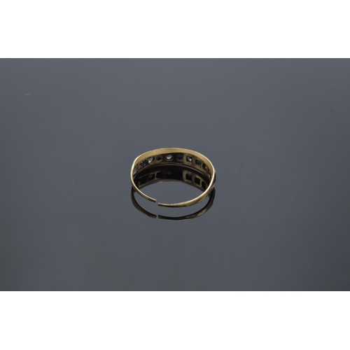 222 - A 9ct gold ladies ring set with diamond and sapphires (possibly synthetic). The band has been cut. G... 