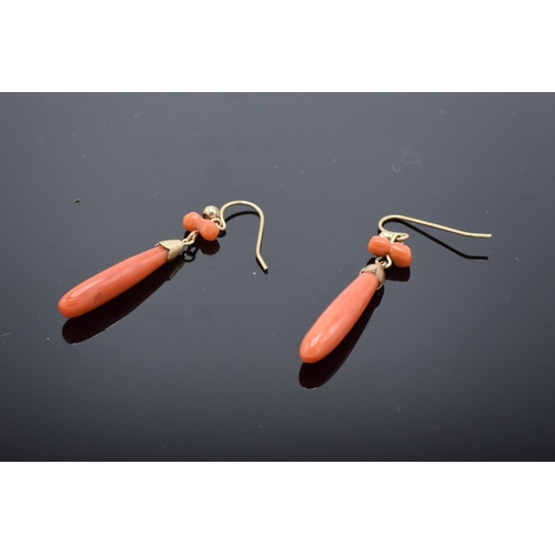 229 - A pair of gold and coral ladies drop-pendant earrings (2). Tests as 9ct or better.