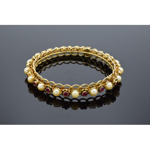 230 - Quality silver gilt bangle set with ruby and pearl stones.