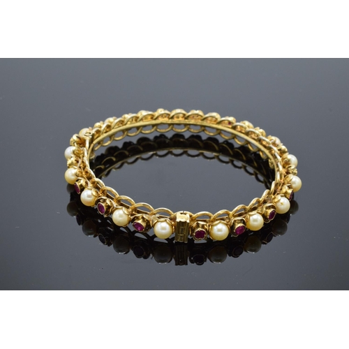 230 - Quality silver gilt bangle set with ruby and pearl stones.