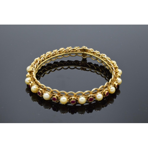 230 - Quality silver gilt bangle set with ruby and pearl stones.