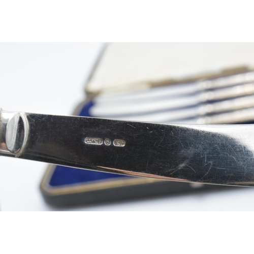 233 - A cased set of silver handled small knives, hallmarked Sheffield 1919.