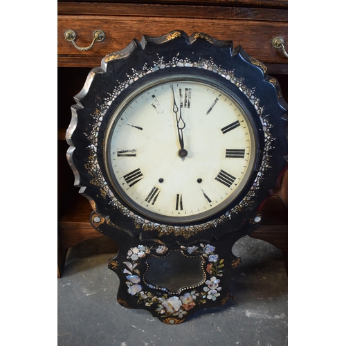 256 - A Victorian papier-mache wall clock decorated with Mother of Pearl inlay with Roman numerals painted... 