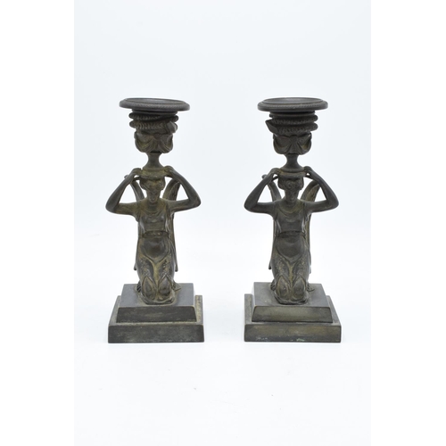 261 - A pair of 19th century Grand Tour Bronze candlesticks depicting ladies with wings holding an urn on ... 