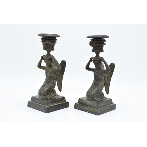 261 - A pair of 19th century Grand Tour Bronze candlesticks depicting ladies with wings holding an urn on ... 