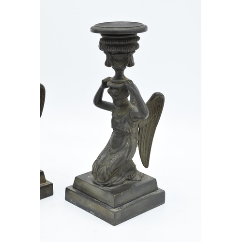 261 - A pair of 19th century Grand Tour Bronze candlesticks depicting ladies with wings holding an urn on ... 