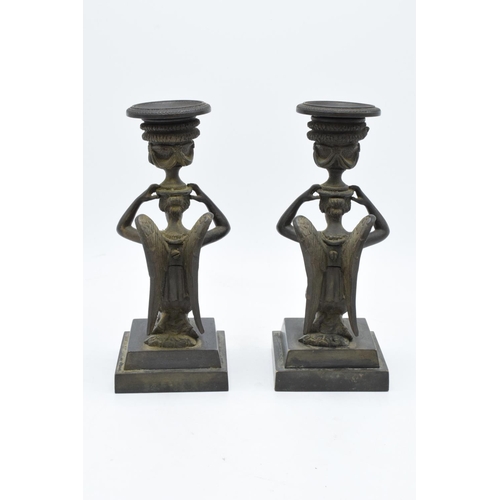 261 - A pair of 19th century Grand Tour Bronze candlesticks depicting ladies with wings holding an urn on ... 