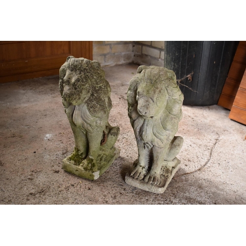 275 - A pair of vintage reconstituted stone upright lions (2). 42 x 15 x 29cm.