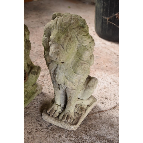 275 - A pair of vintage reconstituted stone upright lions (2). 42 x 15 x 29cm.