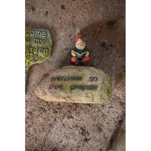 277 - A collection of garden signs to include Beware the Dog, Welcome to our Garden gnome and another Welc... 