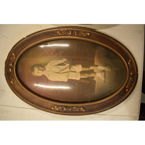 284 - A pair of Edwardian oval frames with scenes depicting a child and a couple. 58cm tall.