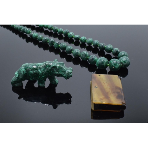 220A - A mixed collection of items to include a malachite figure depicting a rhino, a malachite beaded neck... 