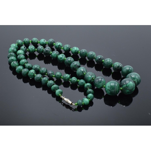 220A - A mixed collection of items to include a malachite figure depicting a rhino, a malachite beaded neck... 