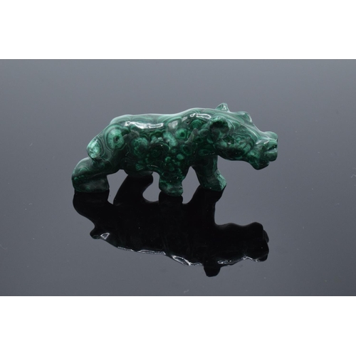 220A - A mixed collection of items to include a malachite figure depicting a rhino, a malachite beaded neck... 