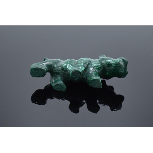 220A - A mixed collection of items to include a malachite figure depicting a rhino, a malachite beaded neck... 