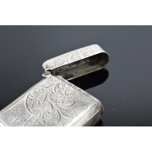 220F - A collection of silver and silver coloured items to include a vesta case (Birmingham 1902) (holes to... 