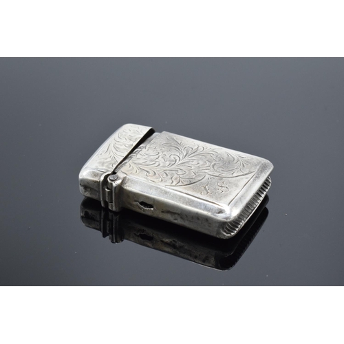 220F - A collection of silver and silver coloured items to include a vesta case (Birmingham 1902) (holes to... 