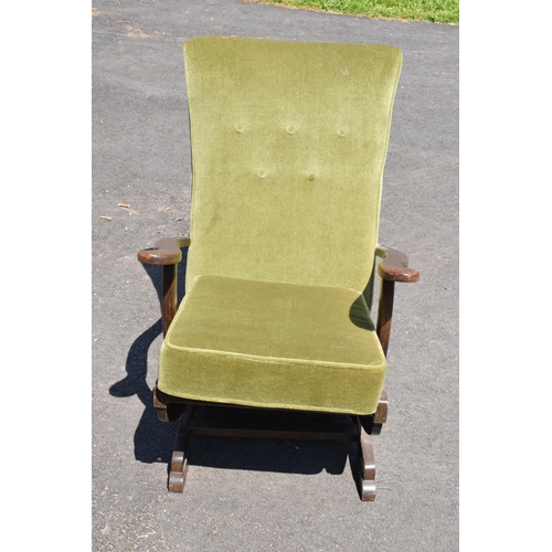 335 - An early to mid 20th century American-style upholstered wooden rocking chair with spring action rock... 