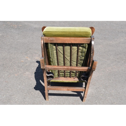 335 - An early to mid 20th century American-style upholstered wooden rocking chair with spring action rock... 