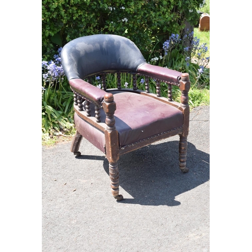 336 - Late Victorian leather tub library chair on caster wheels. 84cm tall.  In need of some attention wit... 