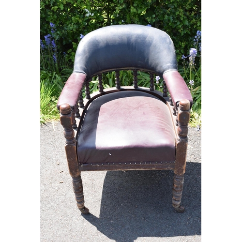 336 - Late Victorian leather tub library chair on caster wheels. 84cm tall.  In need of some attention wit... 