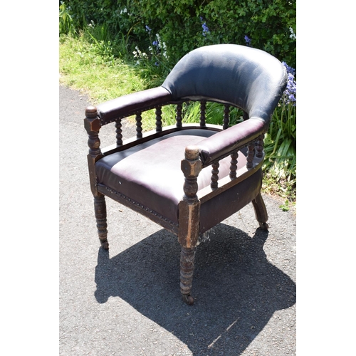 336 - Late Victorian leather tub library chair on caster wheels. 84cm tall.  In need of some attention wit... 