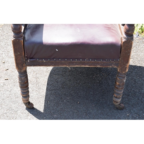 336 - Late Victorian leather tub library chair on caster wheels. 84cm tall.  In need of some attention wit... 