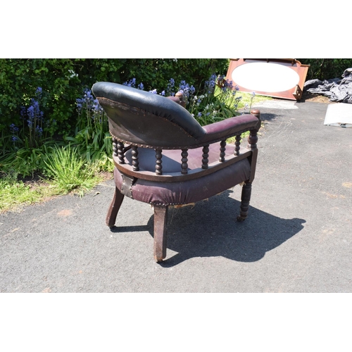 336 - Late Victorian leather tub library chair on caster wheels. 84cm tall.  In need of some attention wit... 