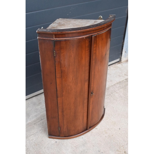 352 - A late 19th century mahogany bow-fronted corner cupboard 94cm tall. In good functional with some age... 