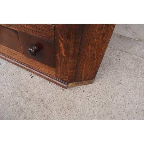 354 - A Georgian period oak corner cupboard with raised sections and a single drawer. 128cm tall, 82cm at ... 