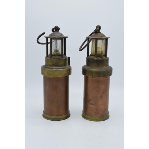 209 - A pair of brass and copper miner's lamps 28cm tall. In good condition and display well. Sold as deco... 