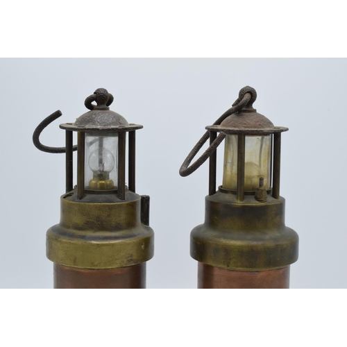 209 - A pair of brass and copper miner's lamps 28cm tall. In good condition and display well. Sold as deco... 