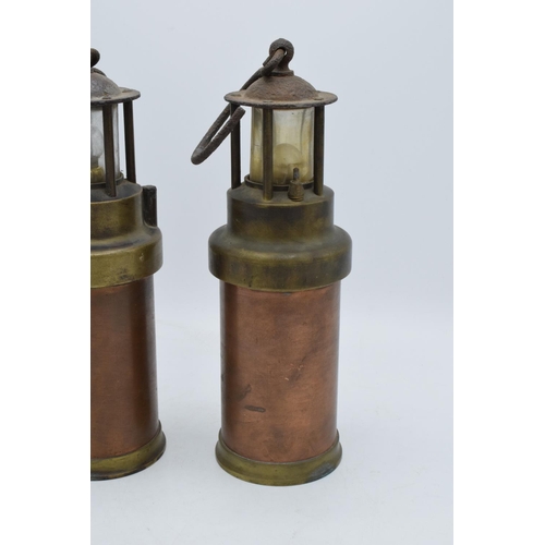 209 - A pair of brass and copper miner's lamps 28cm tall. In good condition and display well. Sold as deco... 