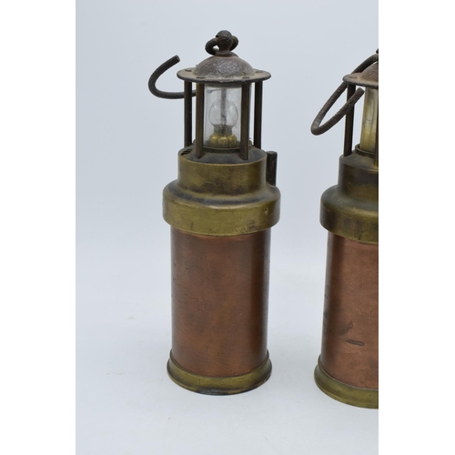 209 - A pair of brass and copper miner's lamps 28cm tall. In good condition and display well. Sold as deco... 