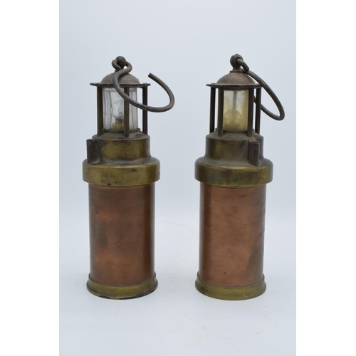 209 - A pair of brass and copper miner's lamps 28cm tall. In good condition and display well. Sold as deco... 