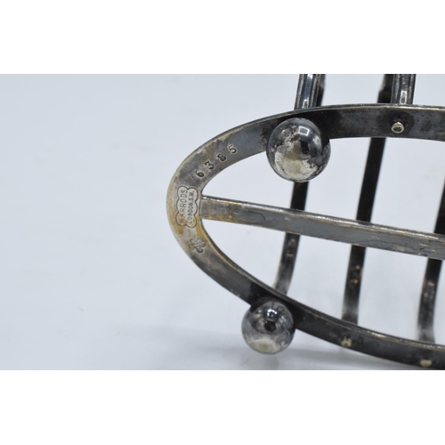 215A - A near pair of silver plated toast racks marked 'Harrods London'. 13cm diameter.