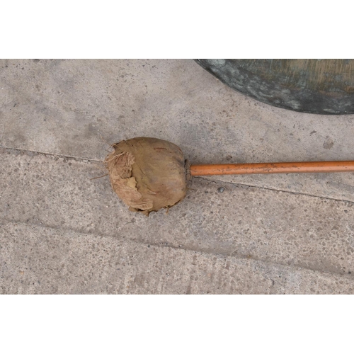 233 - A large hanging gong with striker. 48cm diameter