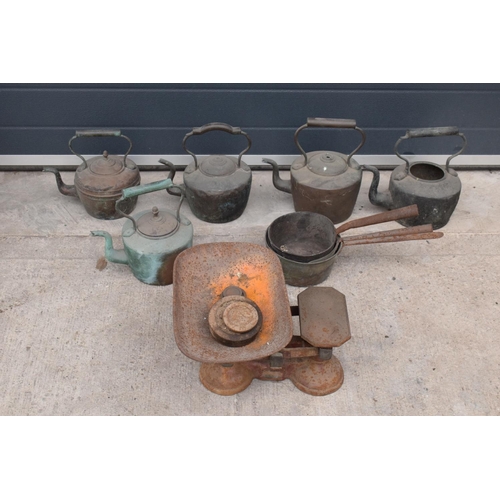 236 - A large collection of 19th and 20th century copper teapots, brass saucepans, scales and a large wick... 